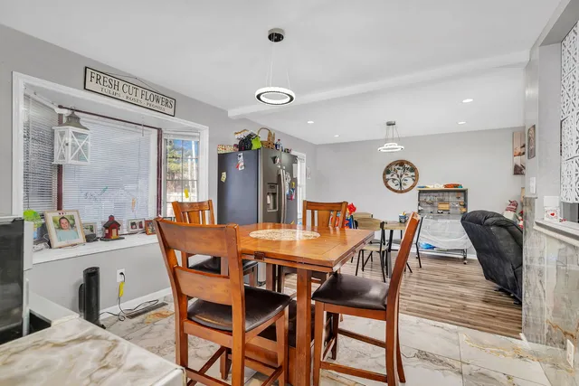 a view of a dining room with furniture and a chandelier