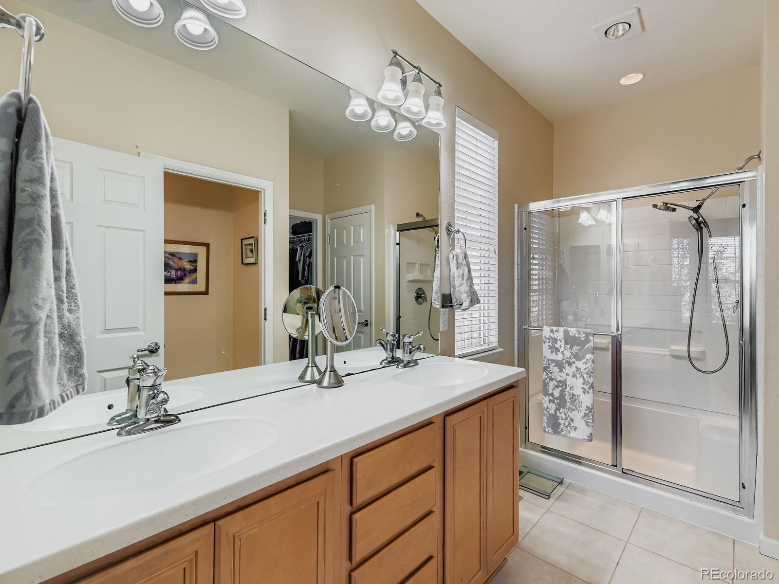 16545 Antero Circle Broomfield, CO 80023 - Photo 13 of 29 a bathroom with a double vanity sink mirror and shower