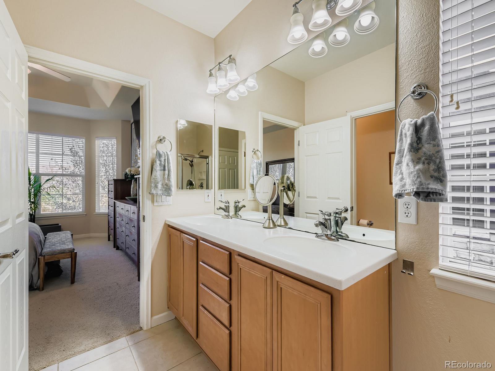 16545 Antero Circle Broomfield, CO 80023 - Photo 14 of 29 a spacious bathroom with a sink double vanity and a mirror