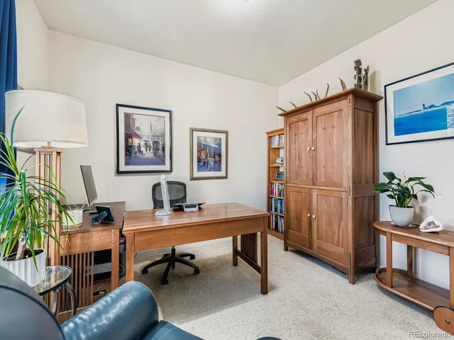 a work room with furniture and a potted plant