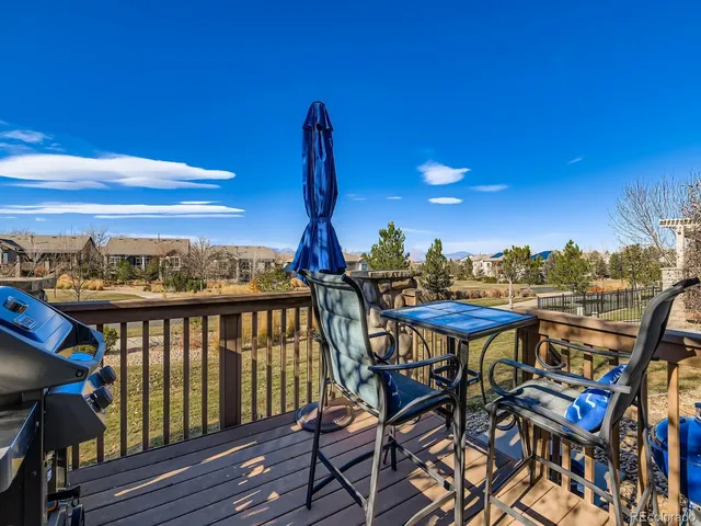 a view of a balcony with furniture and wooden floor