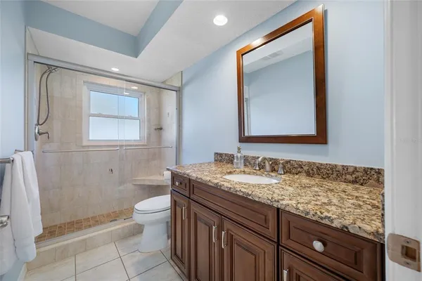 a view of bathroom with a toilet sink and mirror