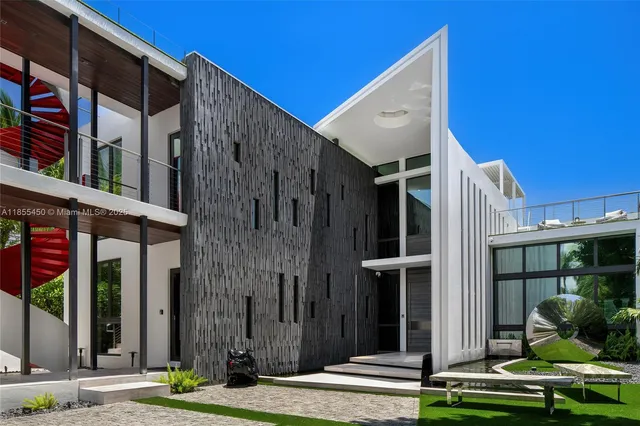 a view of a swimming pool with a lounge chair and palm trees
