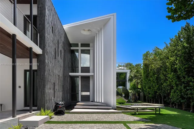 a view of an outdoor sitting area with furniture and floor to ceiling window