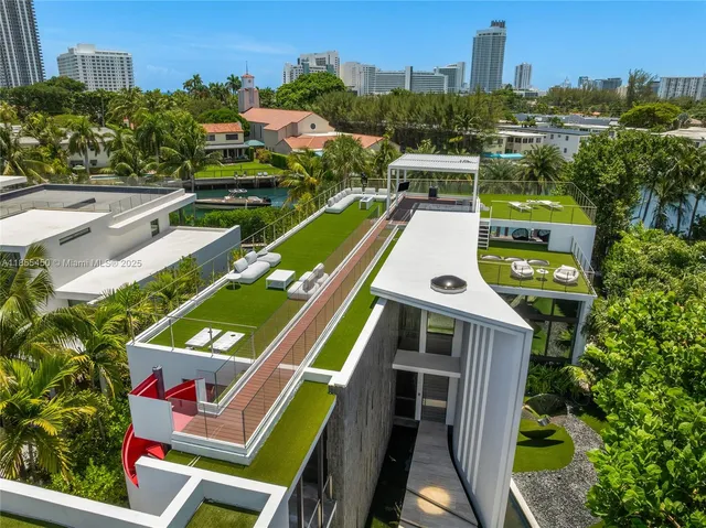 a view of swimming pool with seating area and trees in the background