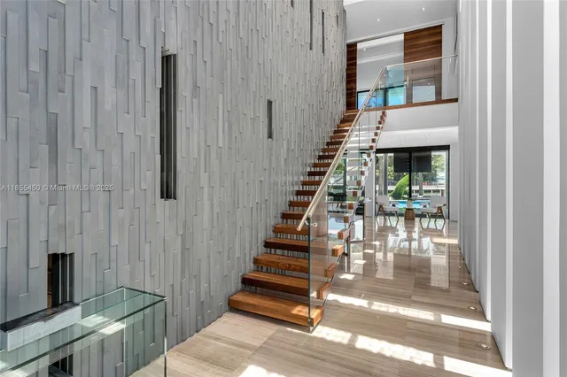 a kitchen with stainless steel appliances kitchen island granite countertop a sink dishwasher a stove and a microwave oven with cabinets