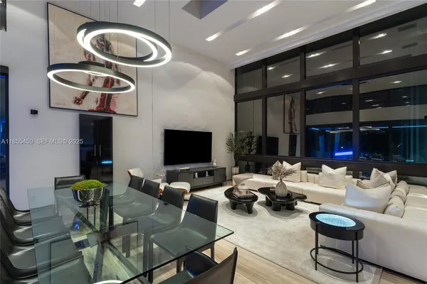 a hallway with painting on the wall and a flat screen tv