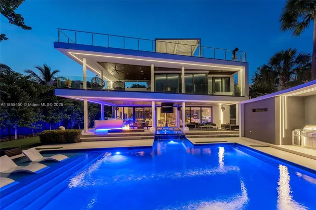 a room with furniture pool table and large windows