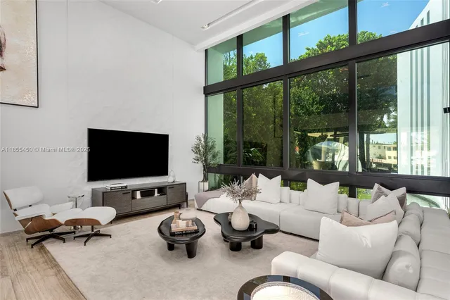 a view of a patio with table and chairs potted plants with wooden floor