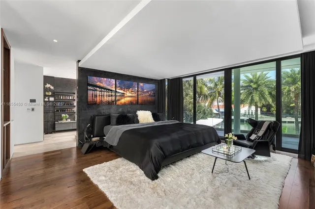 a bedroom with bed and a flat screen tv