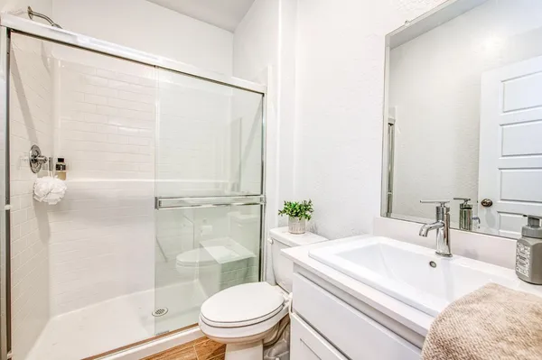 a bathroom with a sink toilet and shower