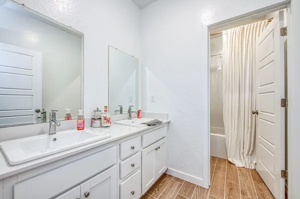 a bathroom with a double vanity sink mirror and double