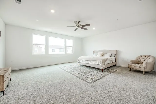 a bedroom with a large bed and a large window