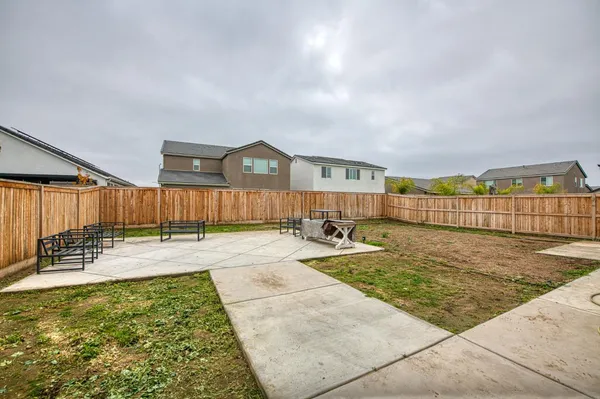 a swimming pool with outdoor seating and yard