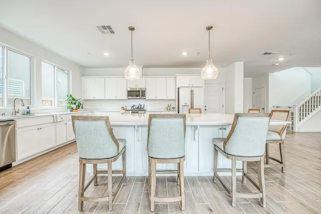 a large kitchen with a table and chairs