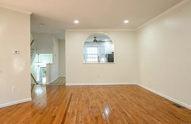 an empty room with wooden floor and a window
