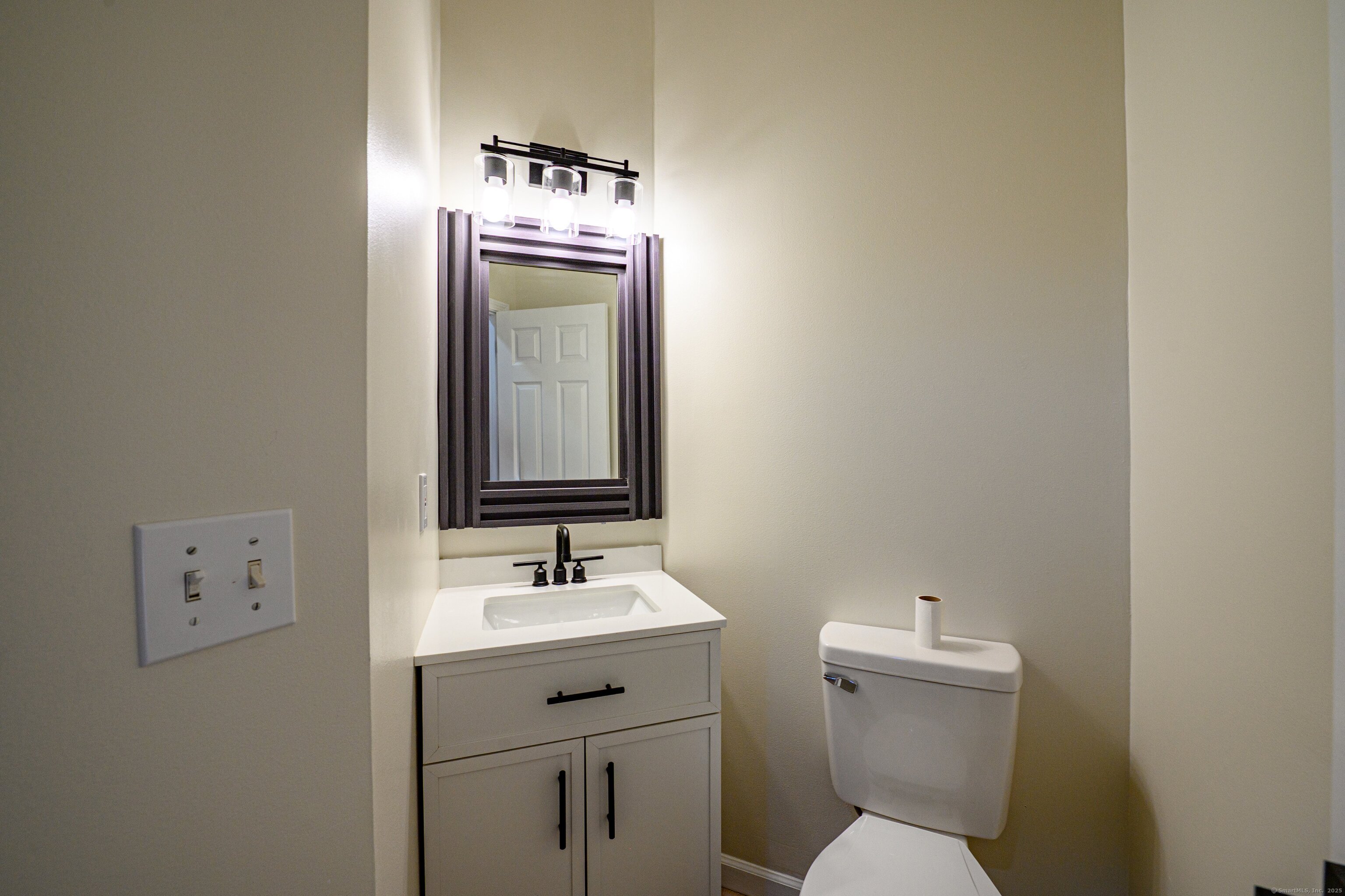 1 Munson Drive, Unit 3 Wallingford, CT 06492 - Photo 15 of 38 a bathroom with a toilet sink and mirror