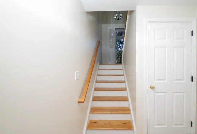 a view of a hallway with wooden floor and entryway