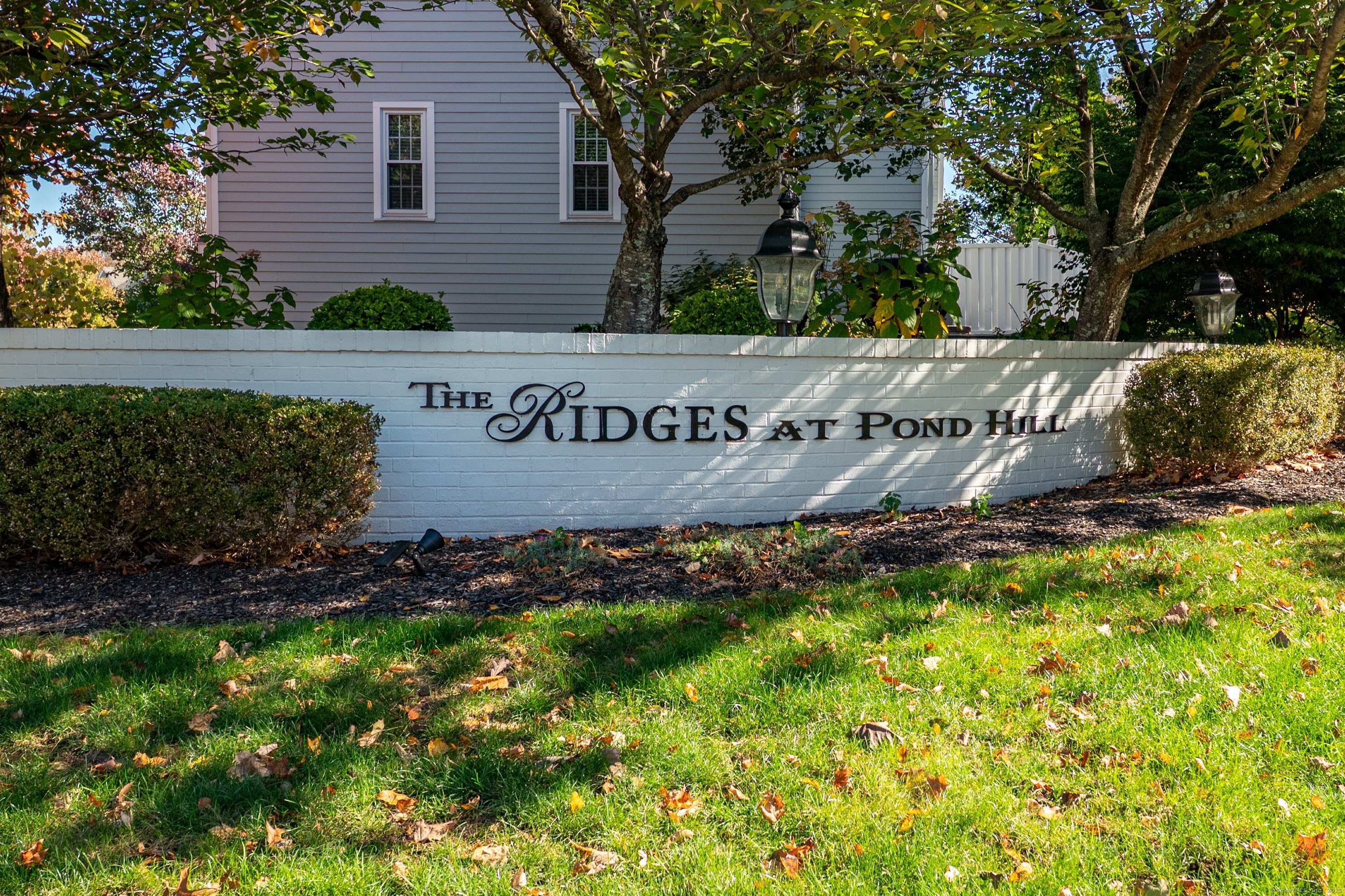 1 Munson Drive, Unit 3 Wallingford, CT 06492 - Photo 2 of 38 a view of outdoor space with signage and flags