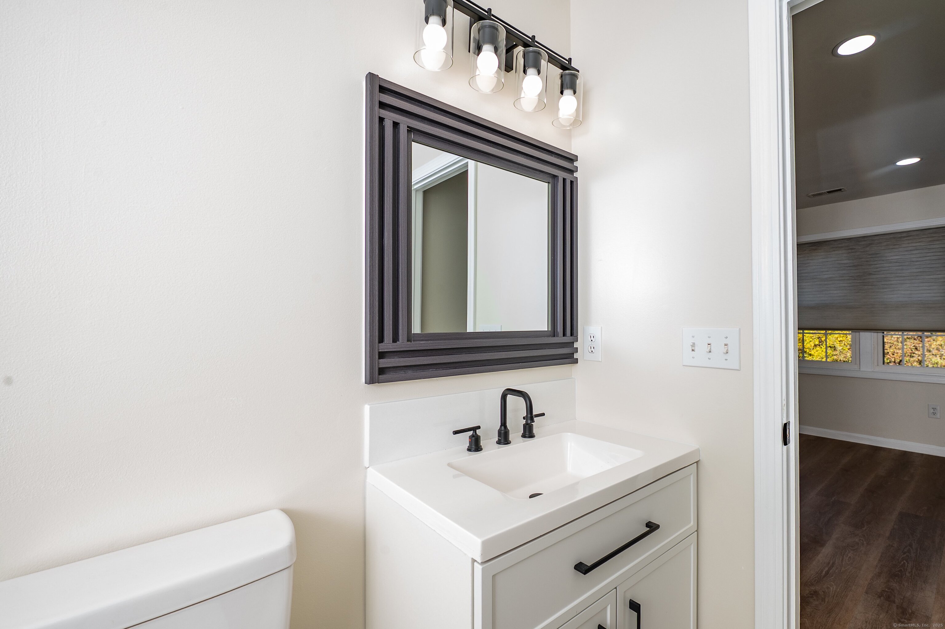 1 Munson Drive, Unit 3 Wallingford, CT 06492 - Photo 24 of 38 a bathroom with a sink and a mirror
