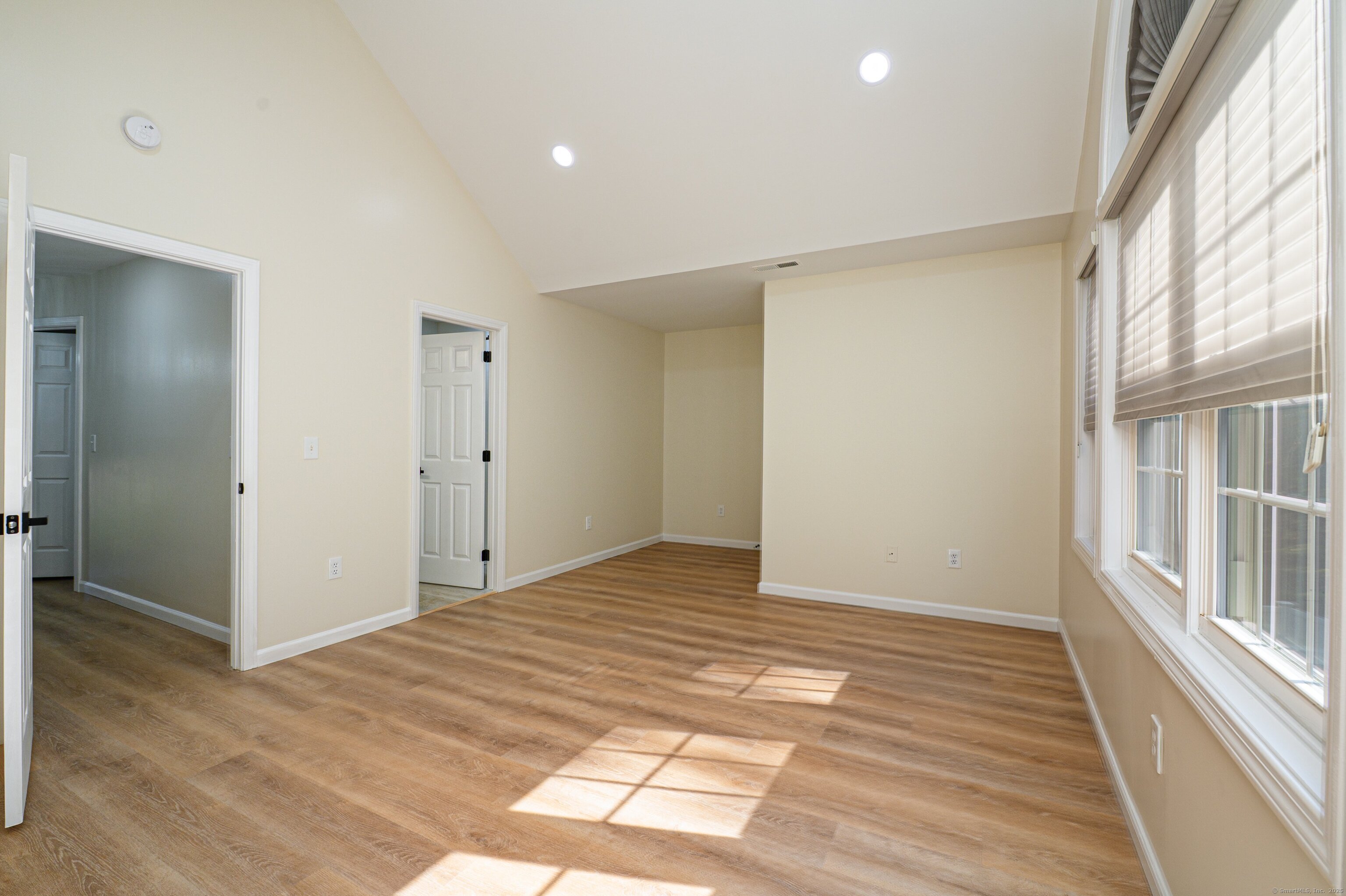 1 Munson Drive, Unit 3 Wallingford, CT 06492 - Photo 26 of 38 a view of an empty room with wooden floor and a window