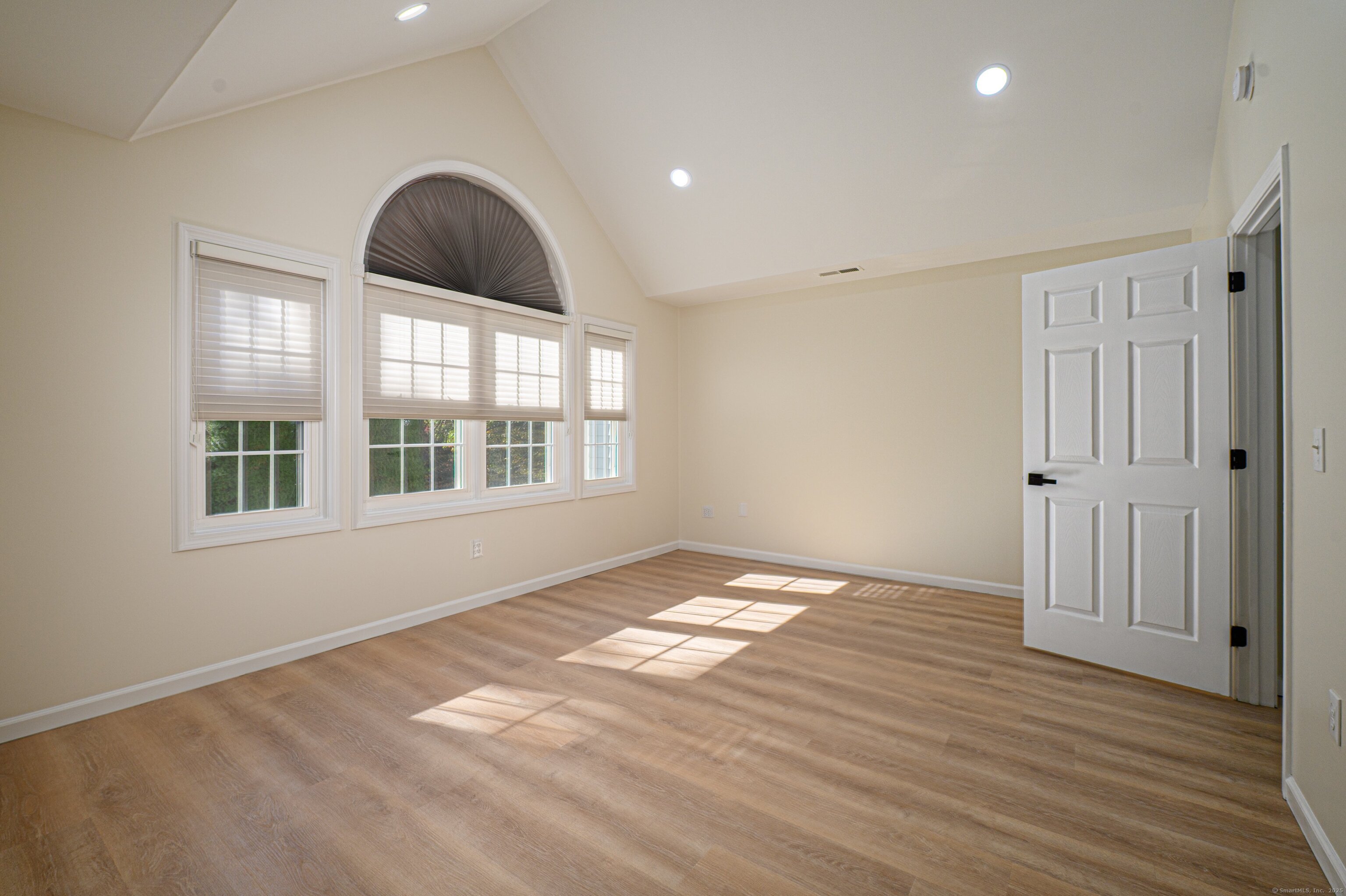 1 Munson Drive, Unit 3 Wallingford, CT 06492 - Photo 28 of 38 a view of an empty room with wooden floor and a window