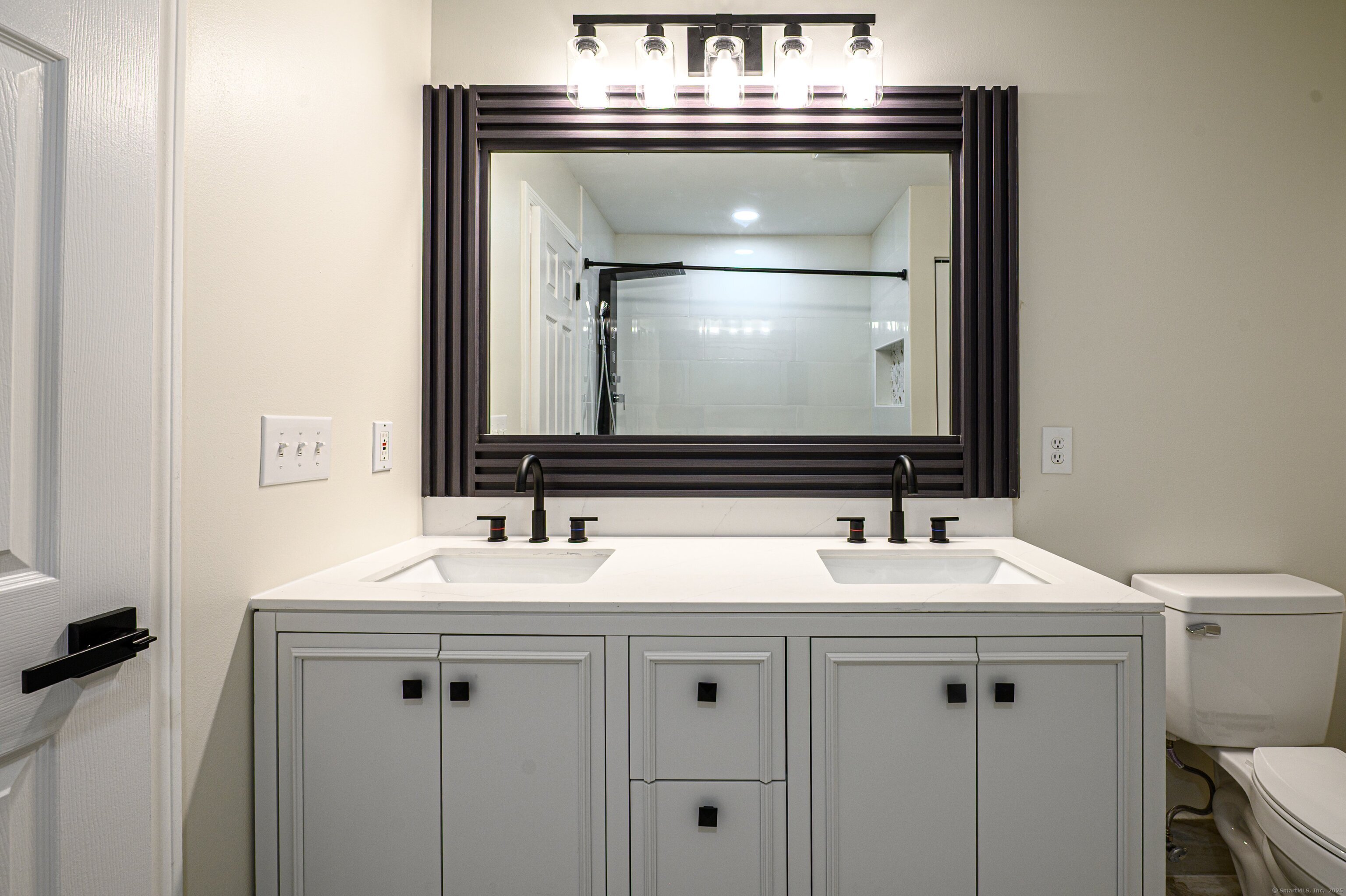 1 Munson Drive, Unit 3 Wallingford, CT 06492 - Photo 29 of 38 a bathroom with a sink and a mirror