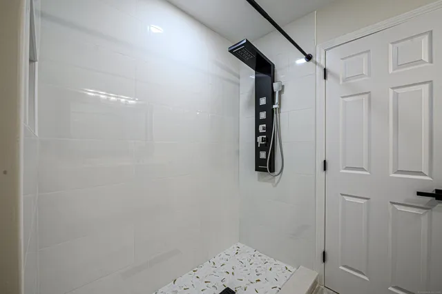 a bathroom with a shower and a shower