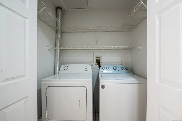 a view of storage and utility room with washer and dryer