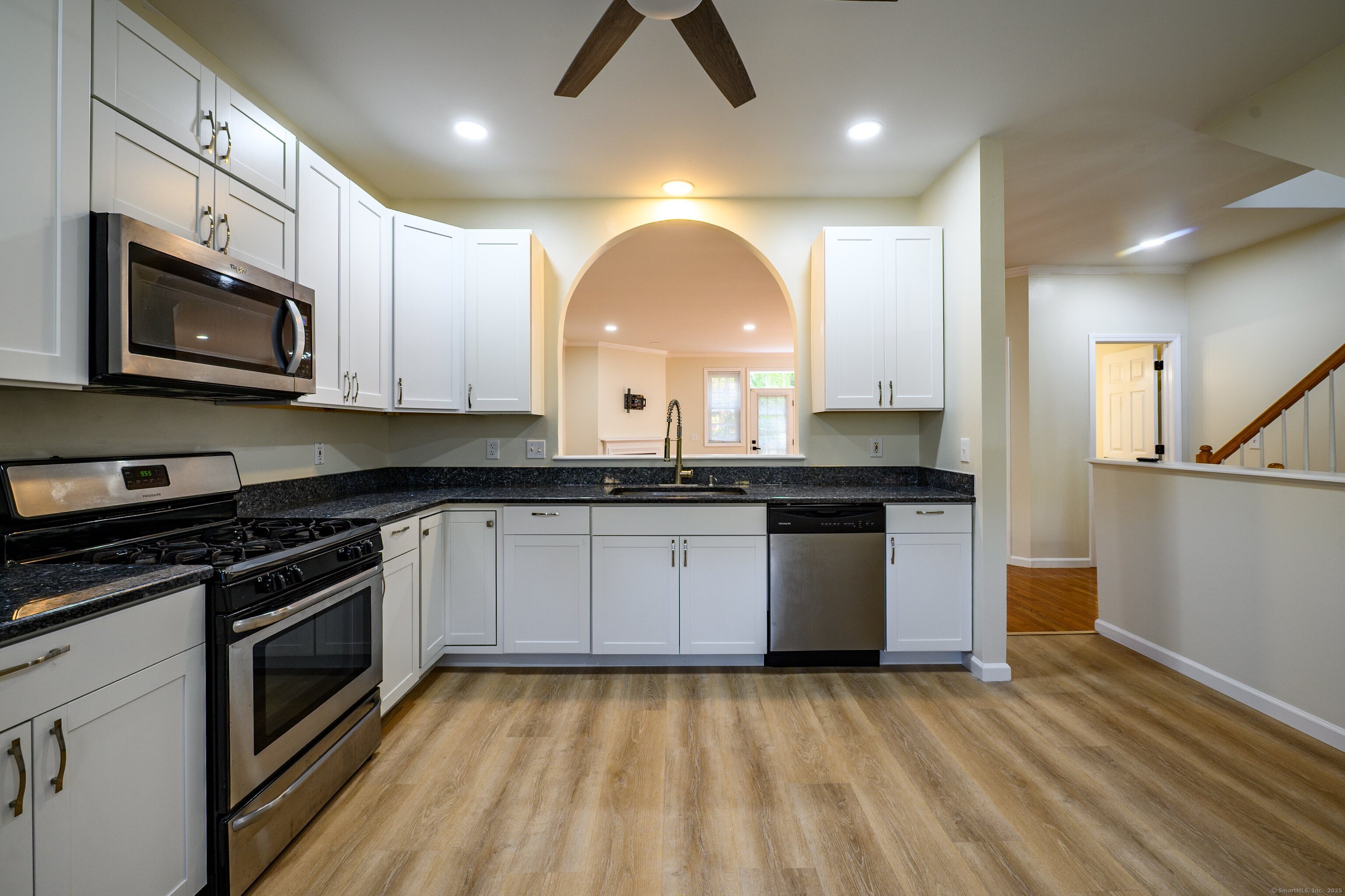 1 Munson Drive, Unit 3 Wallingford, CT 06492 - Photo 9 of 38 a kitchen with stainless steel appliances granite countertop a stove a sink and a microwave