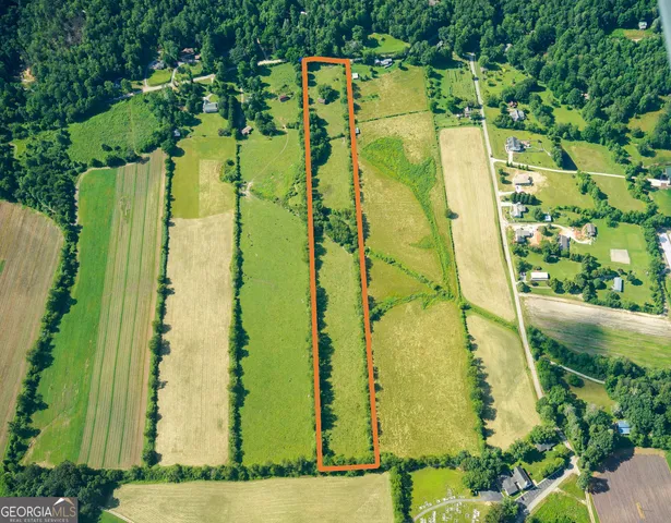 an aerial view of residential house with pool and yard