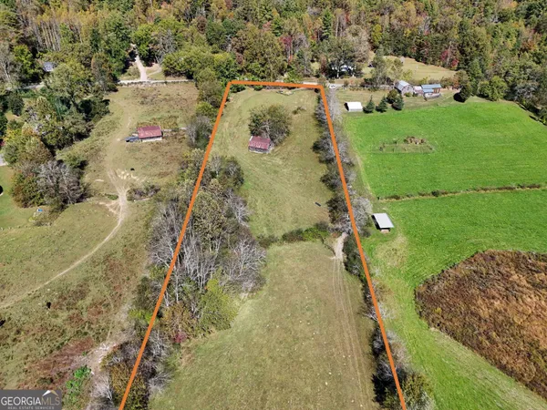 an aerial view of a residential houses with outdoor space
