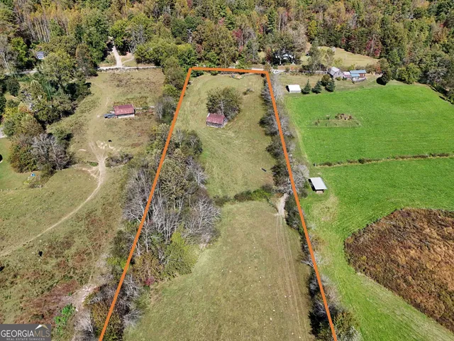 an aerial view of a residential houses with outdoor space