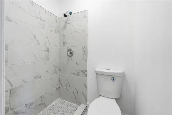 a bathroom with a toilet and a shower