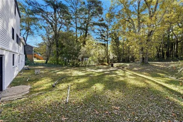 a view of yard with swimming pool and trees