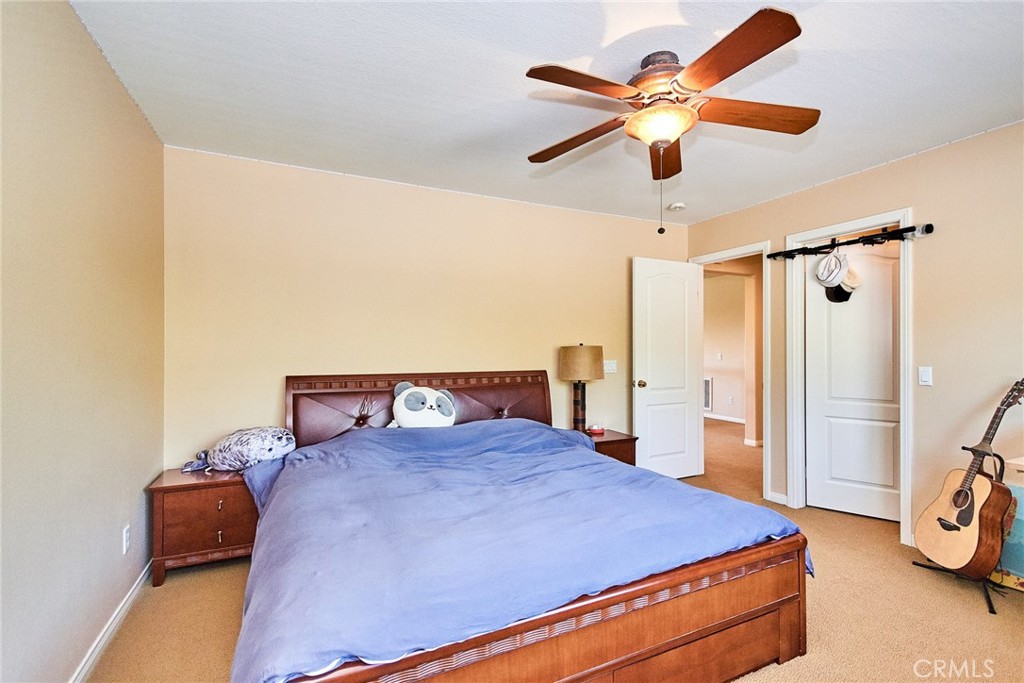 12430 Split Rein Drive Rancho Cucamonga, CA 91739 - Photo 19 of 29 a bedroom with a bed and a ceiling fan