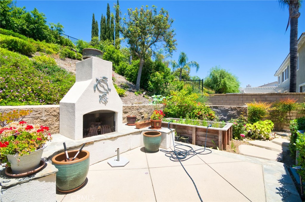 12430 Split Rein Drive Rancho Cucamonga, CA 91739 - Photo 7 of 29 a view of a patio with chair and potted plants