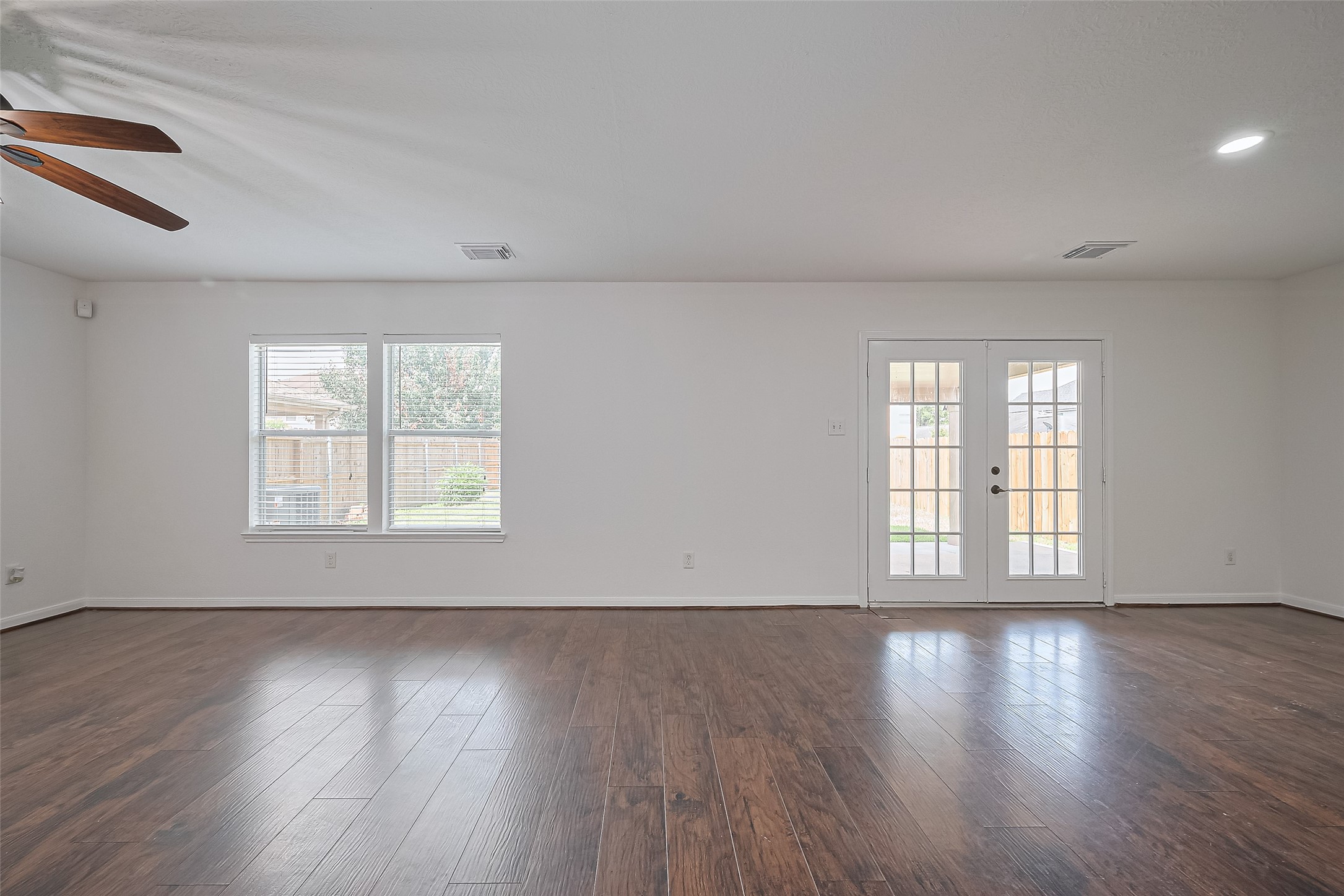 7734 Pasture Bend Lane Cypress, TX 77433 - Photo 9 of 50 a view of an empty room with wooden floor and a window