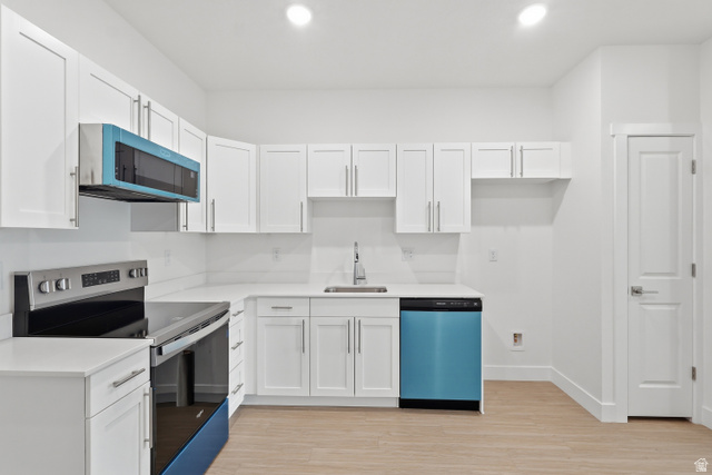 2085 North Main Street, Unit 301 Sunset, UT 84015 - Photo 4 of 20 Kitchen with electric range, white cabinetry, dishwashing machine, and recessed lighting