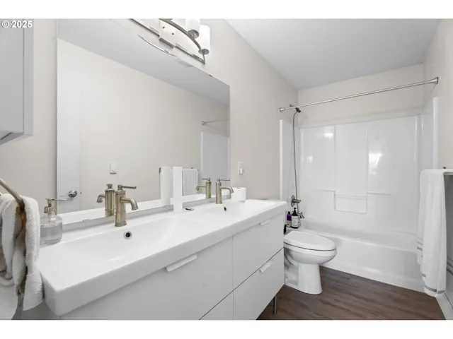 a kitchen with stainless steel appliances a dining table chairs and white cabinets