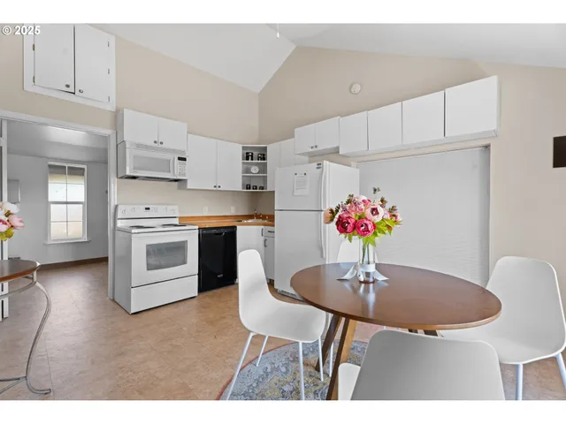 a view of a chairs and table in patio with a lake view