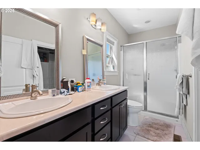 a bathroom with a sink double vanity and a mirror