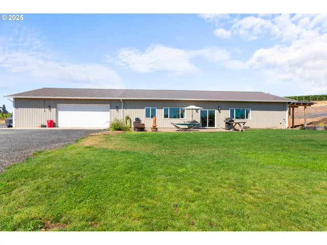 a view of a backyard with sitting area