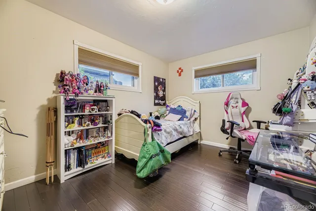 a bedroom with furniture and a book shelf