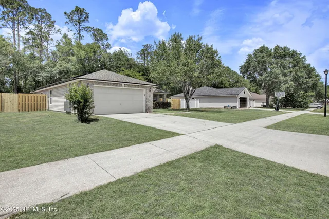 a white house that has a tree in front of it
