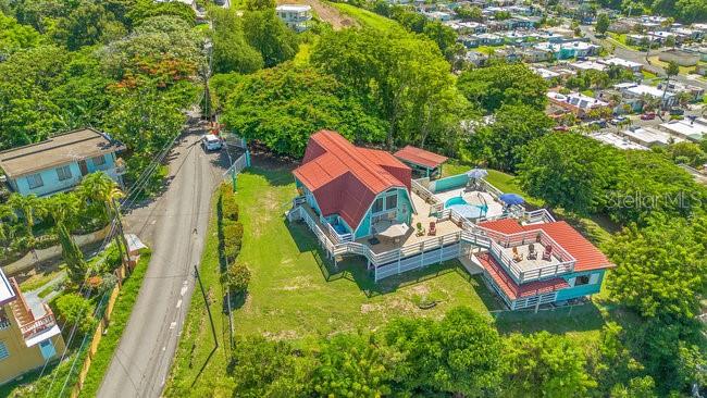 115 Int Km 11.9 Rincon, PR 00677 - Photo 1 of 1 an aerial view of a house with swimming pool and outdoor seating