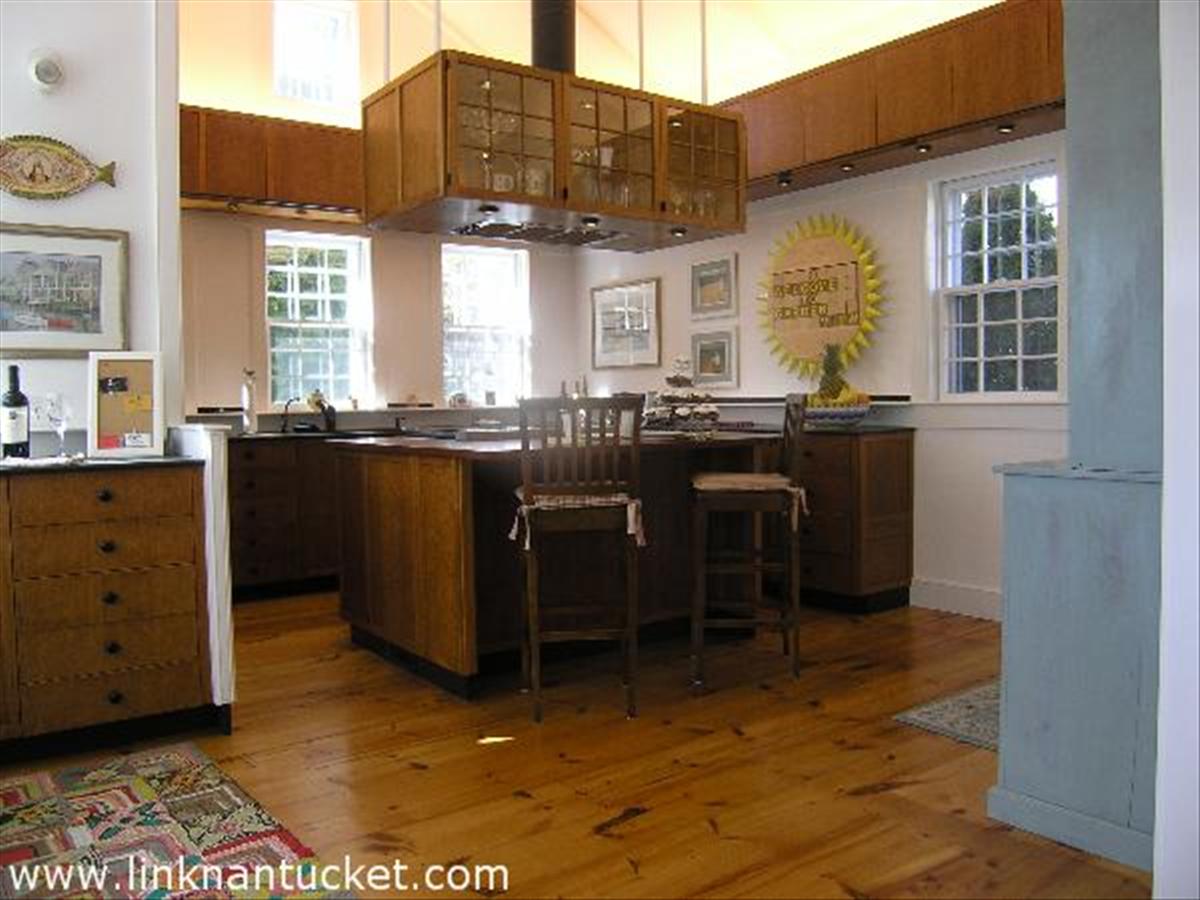 34 R Cliff Road Nantucket, MA 02554 - Photo 5 of 14 a view of a kitchen with granite countertop a stove a sink a dining table and chair
