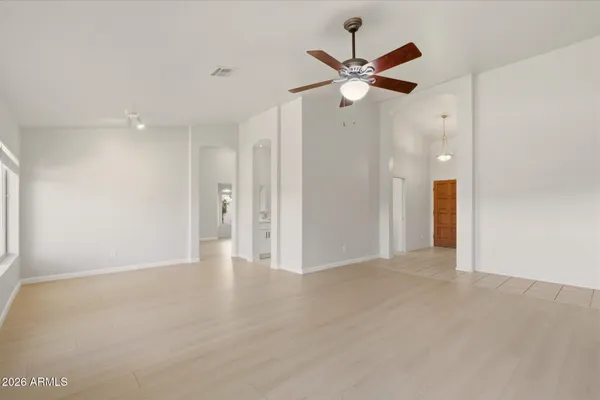 a view of a livingroom with a ceiling fan and window