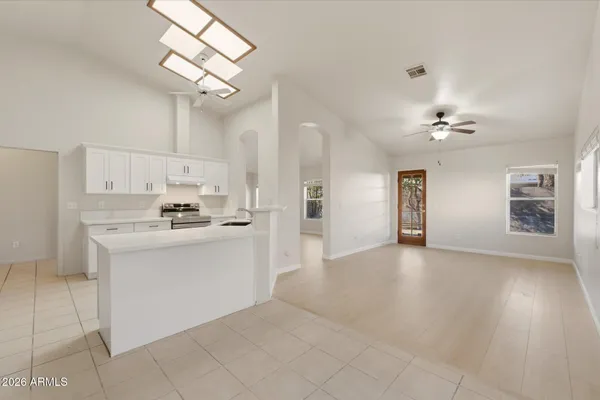 a view of a kitchen with a sink dishwasher a refrigerator and cabinets
