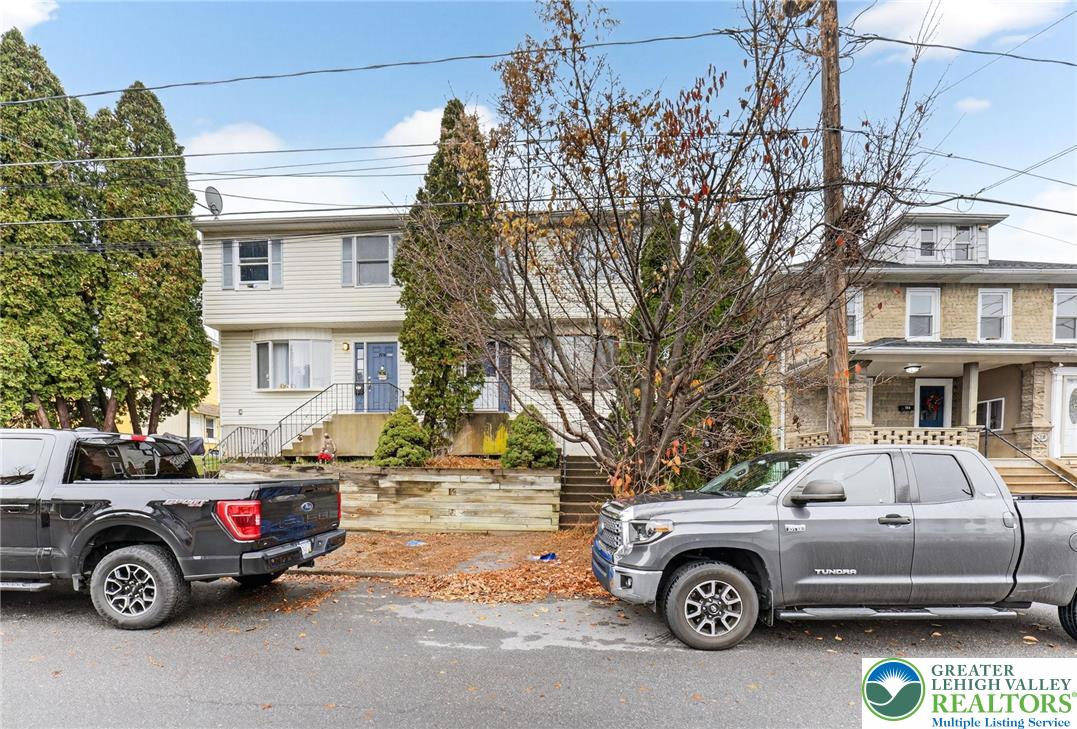 a front view of a house with parking space